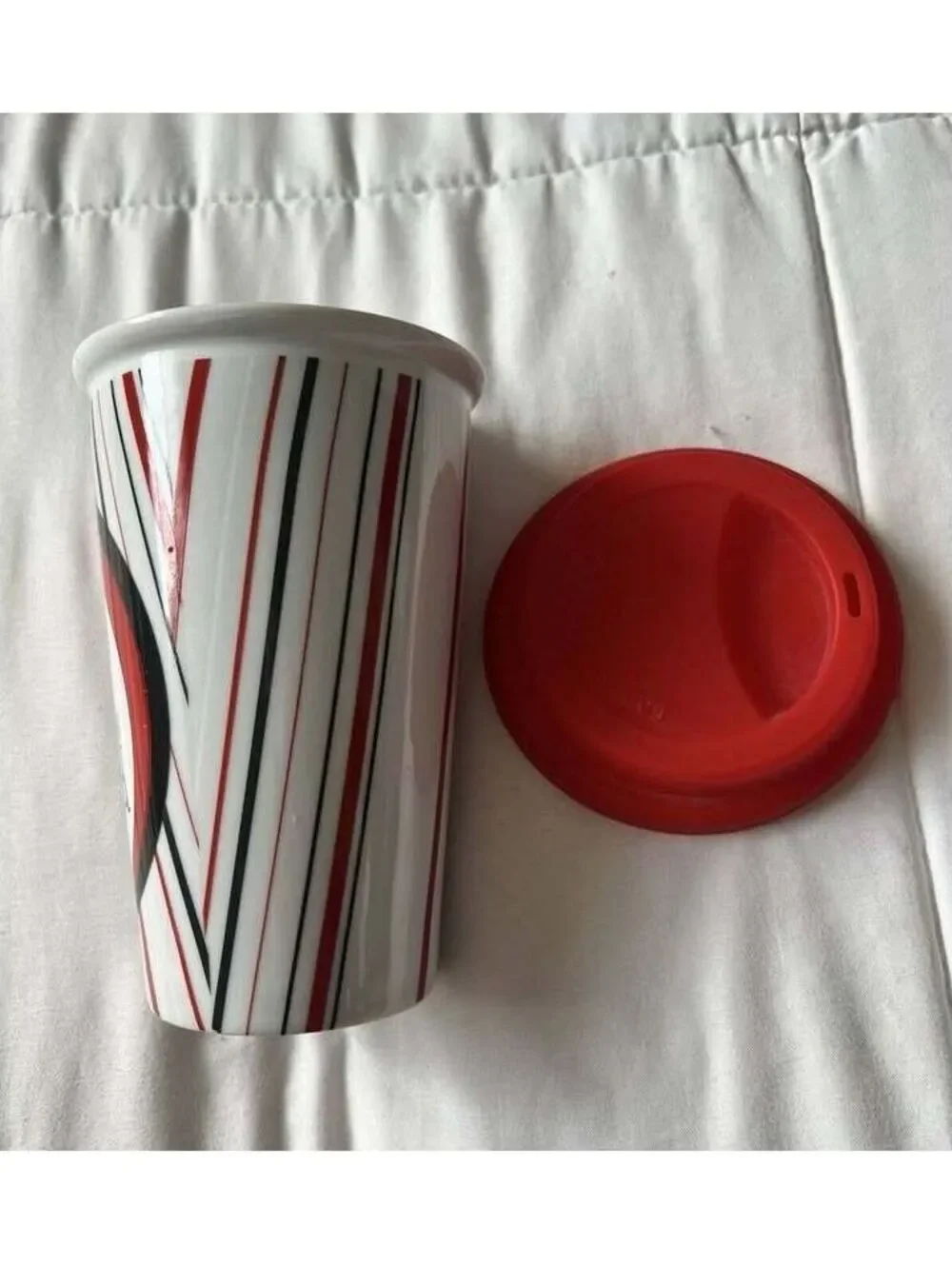DRINKWARE Ceramic Travel Coffee Mug with Red Silicone Lid and Artistic Design